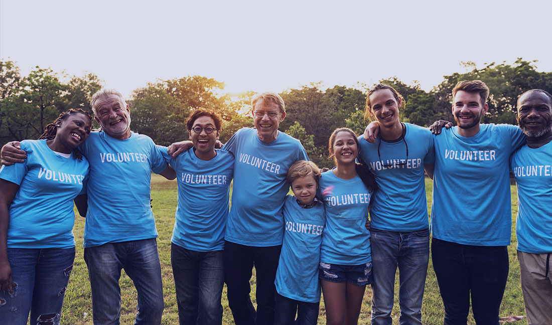 Volunteers team smiling together outdoors